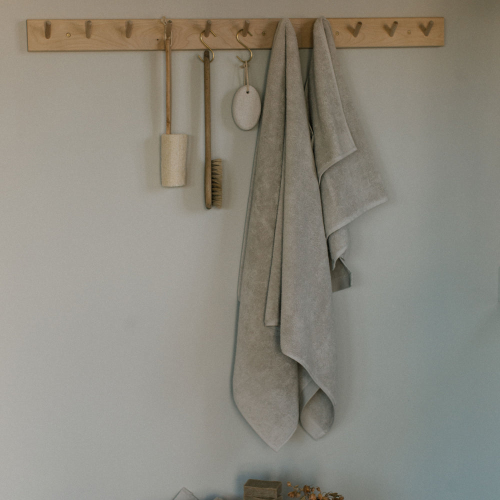 
                  
                    beige organic towel set hanging in pantry
                  
                